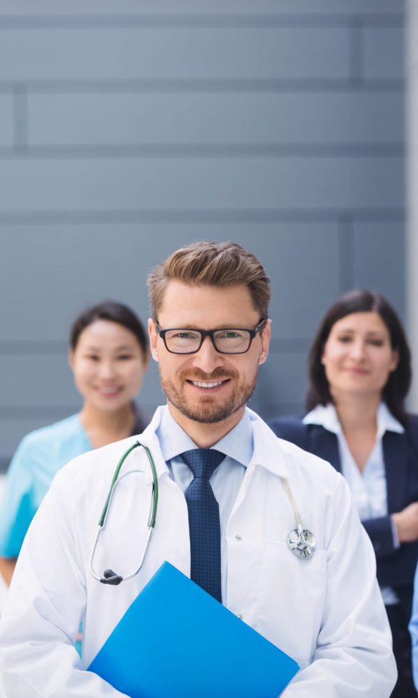 Portrait of smiling doctors standing together in hospital premises